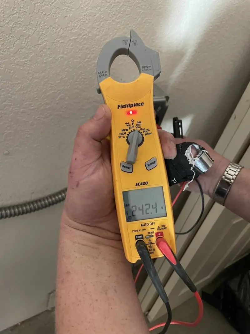 Voltage testing with clamp meter during Recessed Lighting Installation in Glastonbury